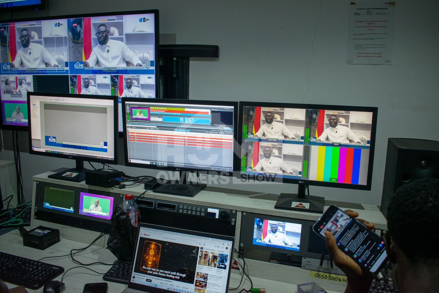 A broadcast control room with multiple monitors displaying live TV feeds and production software.