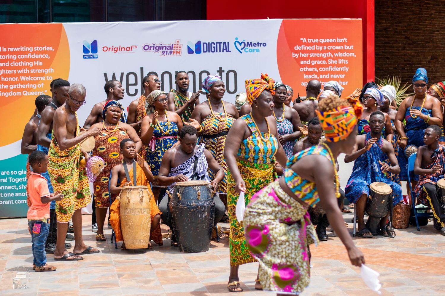 Traditional African dancers performing in Kente cloth at a welcome ceremony.