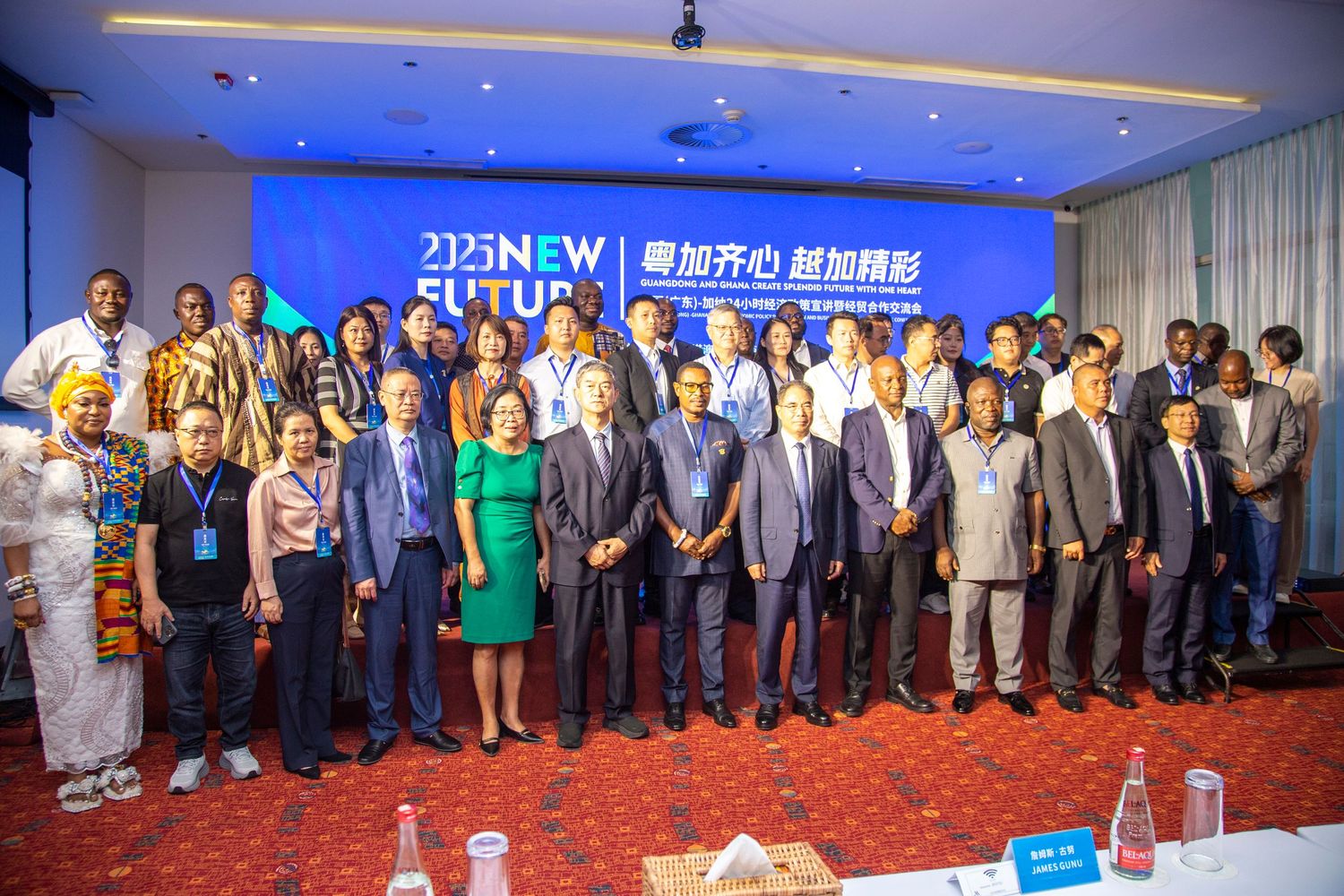 Large diverse group of international delegates posing together at a 2025 New Future conference event.