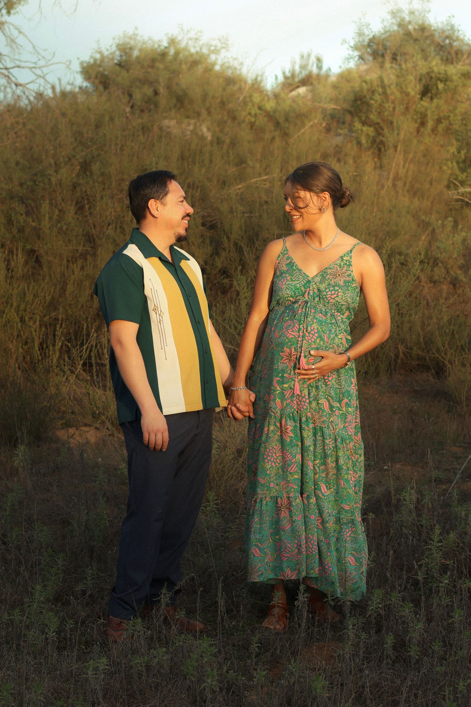 couple walking at sunset in open field