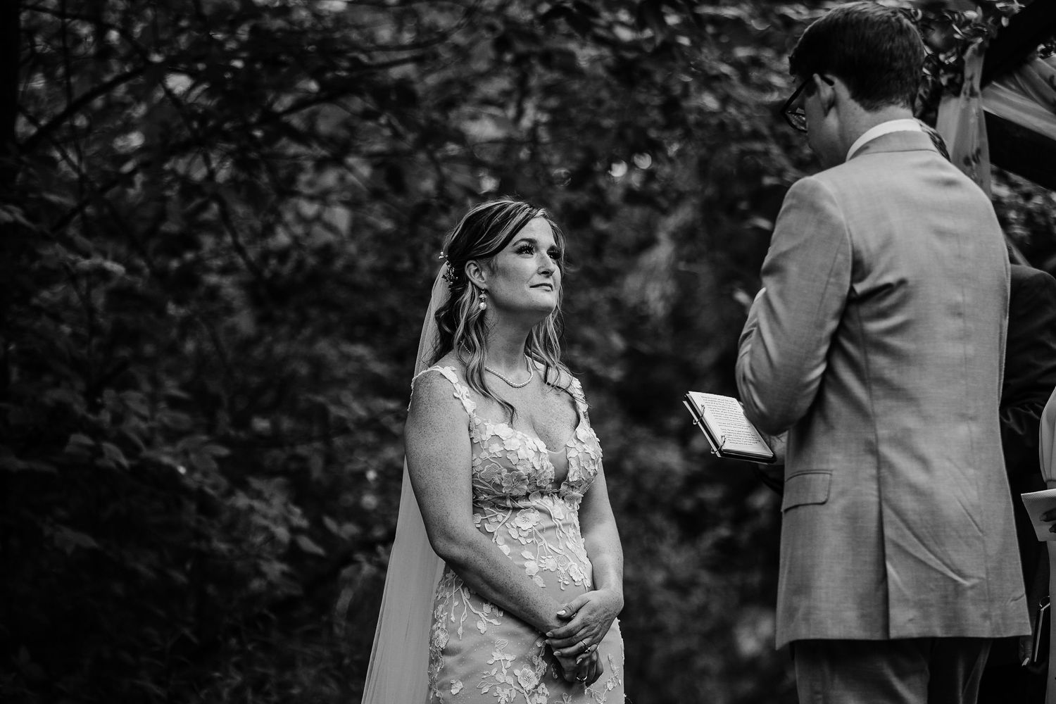 Black and white wedding portraits captured in a natural outdoor setting.