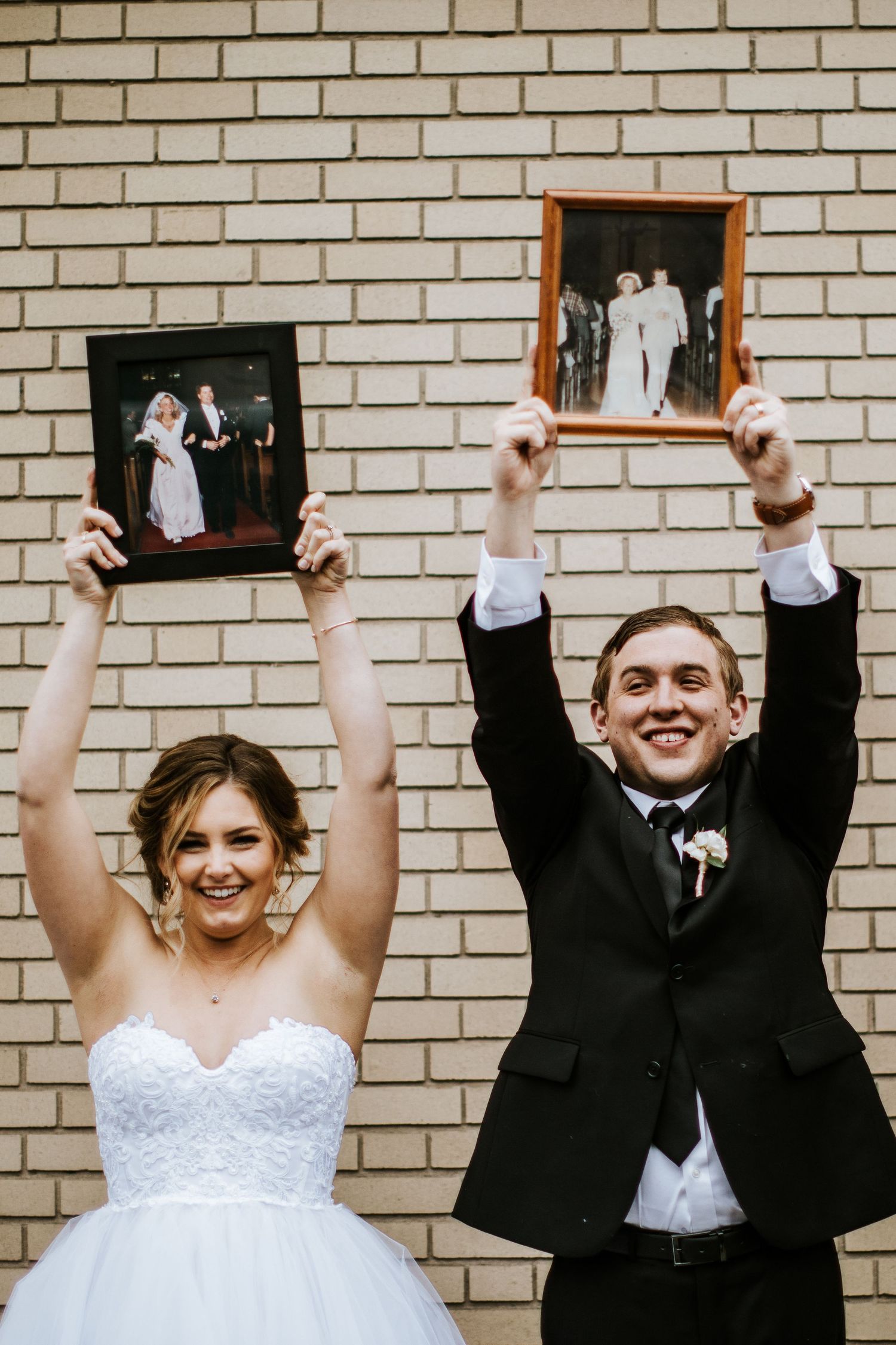 A series of playful wedding photos showing a couple holding picture frames against a brick wall.