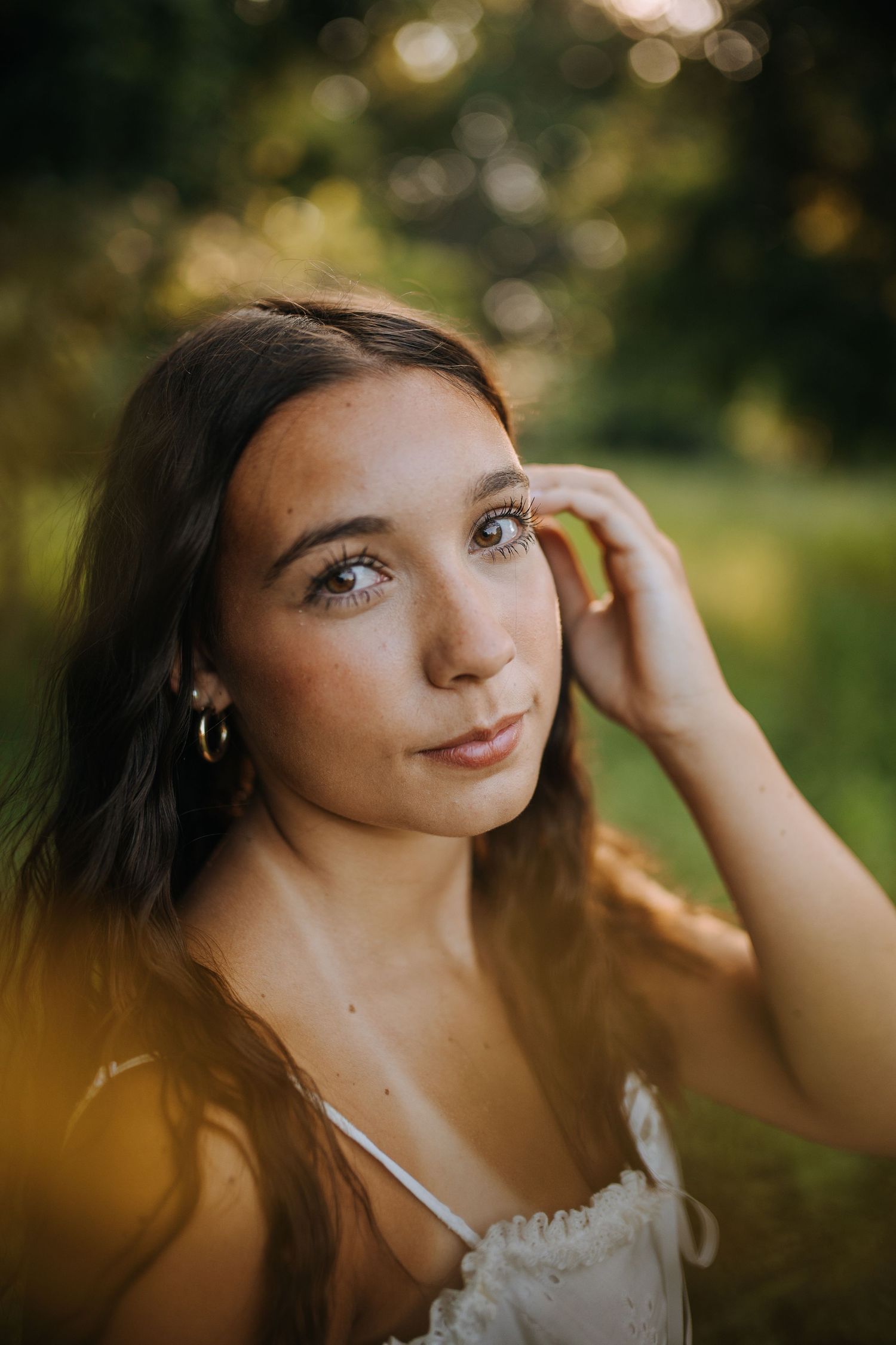 Close-up portrait in natural lighting with bokeh effect and golden hour glow.