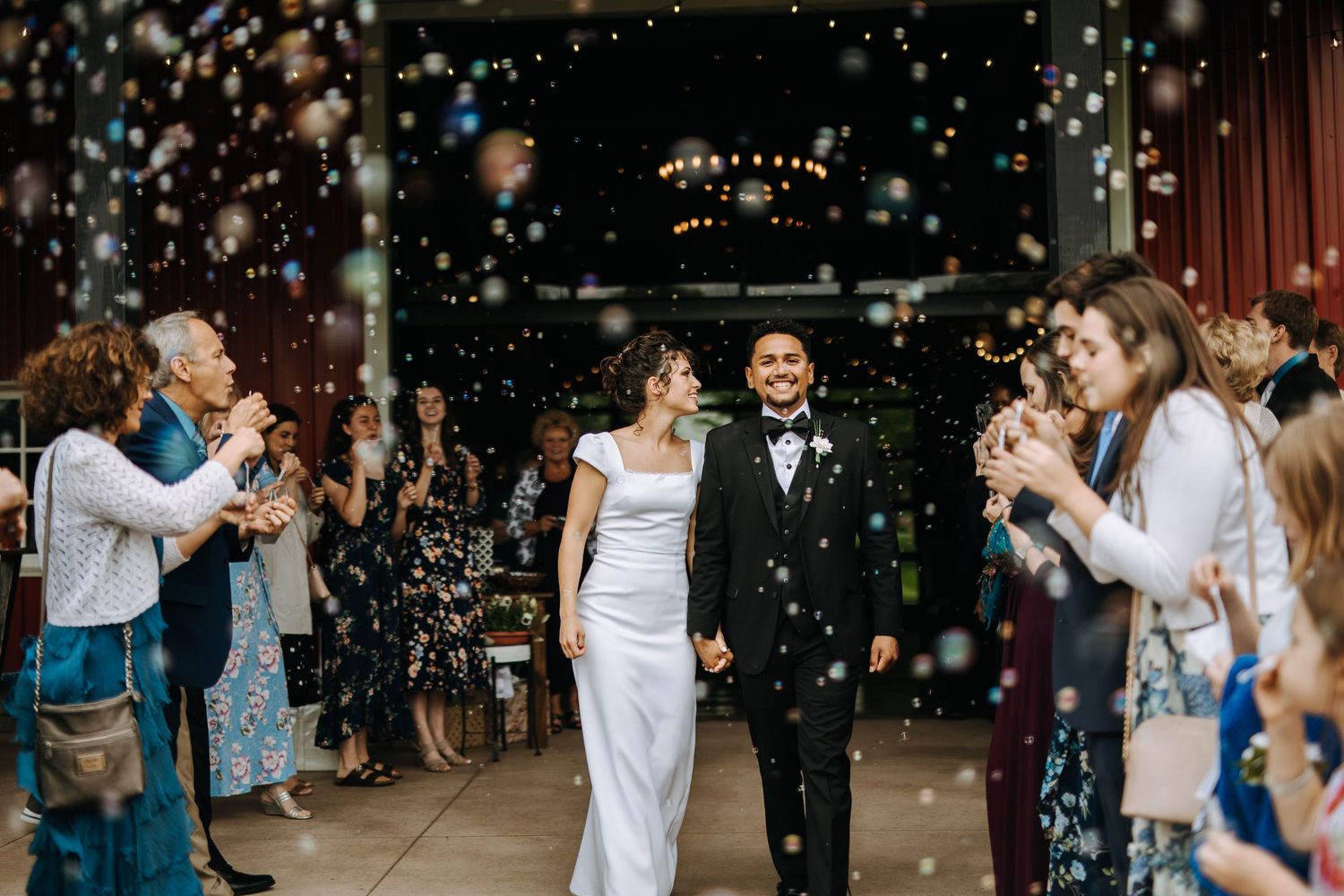Wedding reception dance party with sparklers and festive lighting.