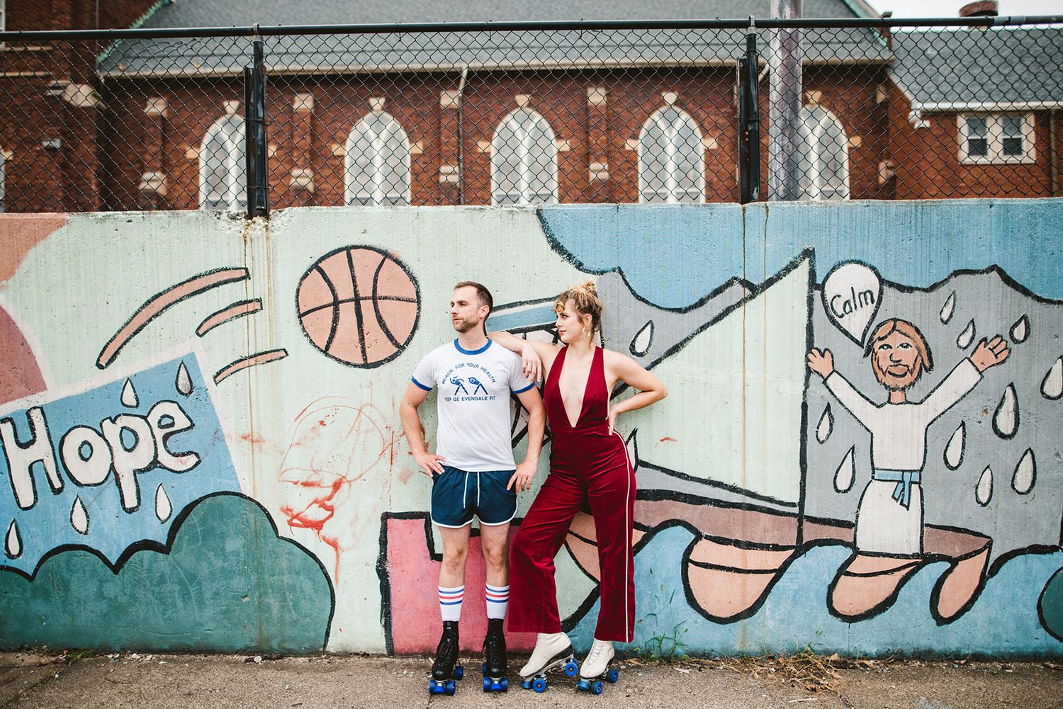 Colorful street art mural featuring basketball and abstract designs on concrete wall.