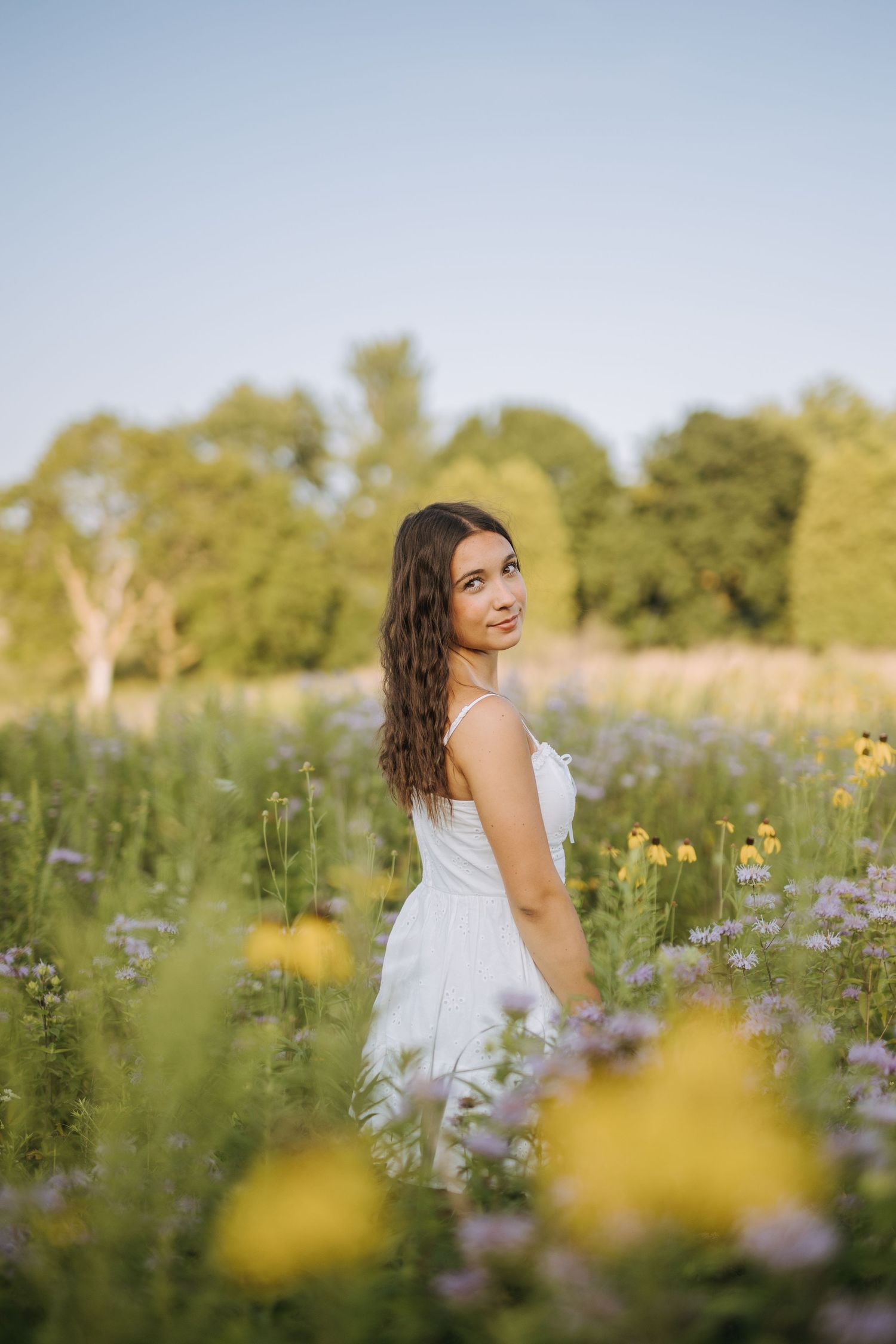 Portrait session in wildflower field during golden hour.