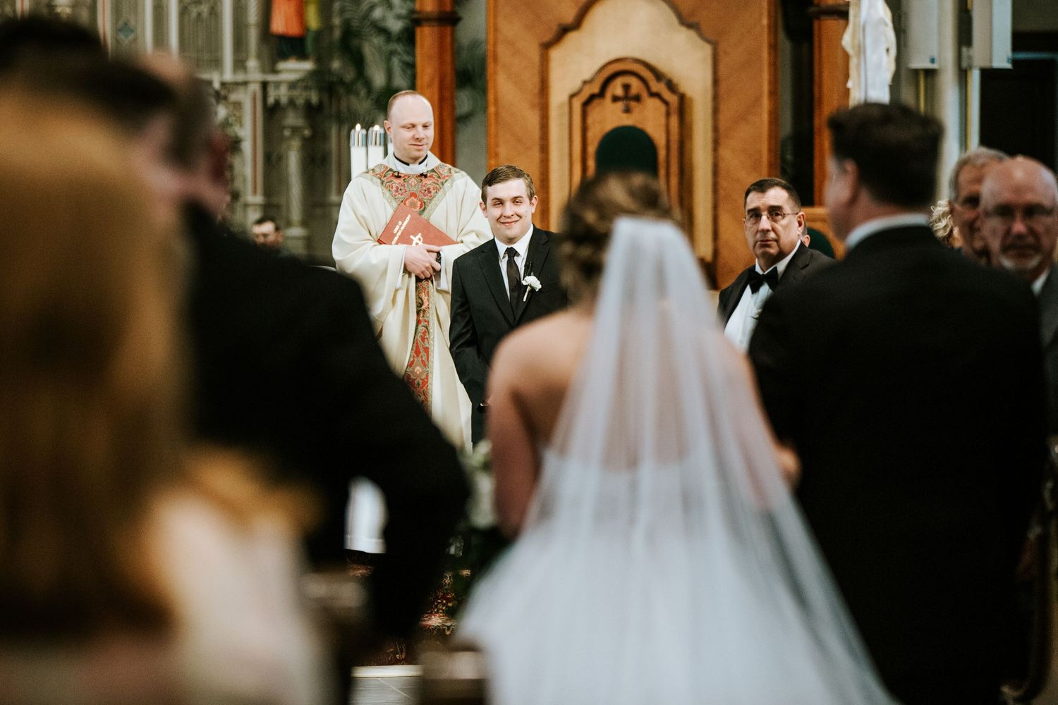 A traditional Catholic wedding ceremony in progress at an ornate church altar.