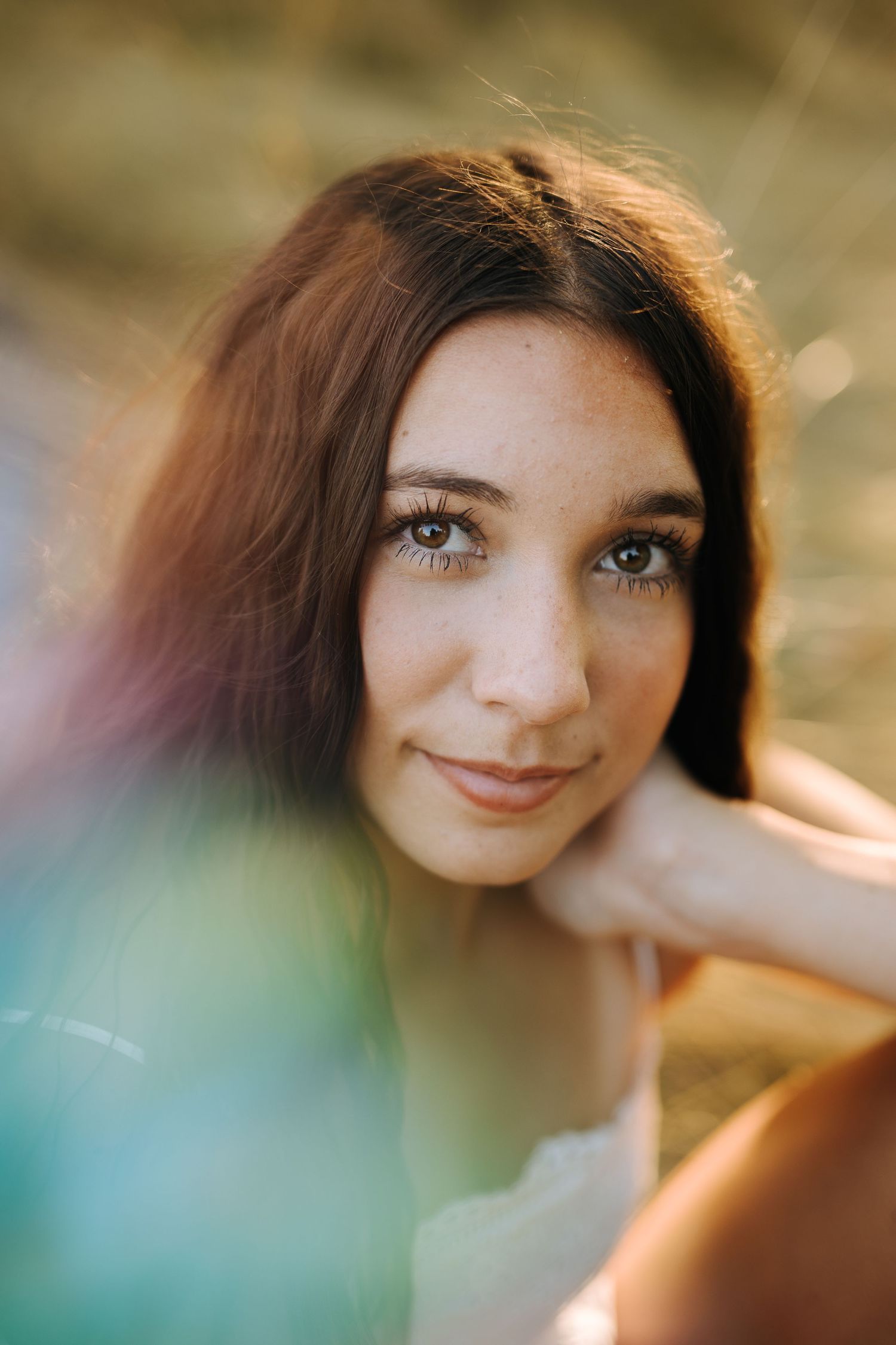 Portrait of someone with bright blue eyes and soft lighting creating a dreamy atmosphere.