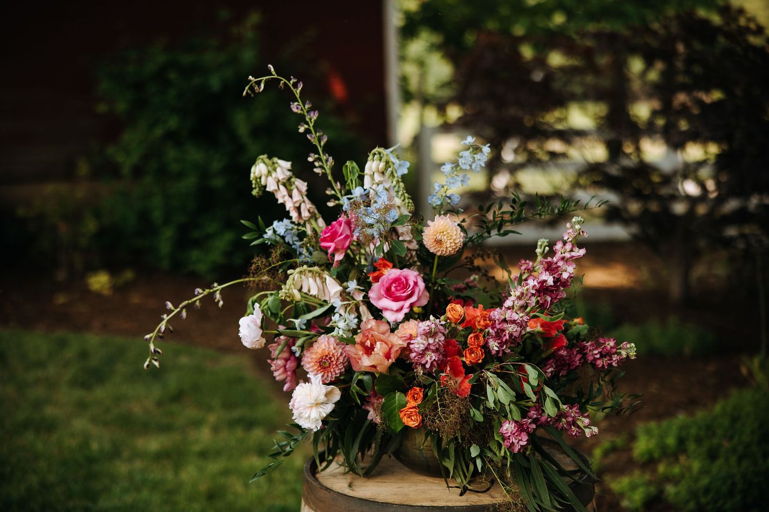 Colorful wedding bouquets displayed on rustic wooden surfaces with pink and orange flowers.