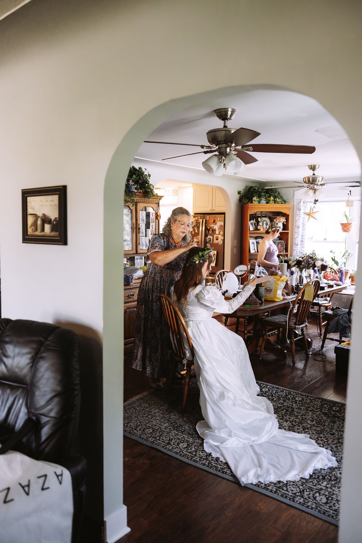 A sequence showing a bride twirling in her white dress inside a home with arched doorways.