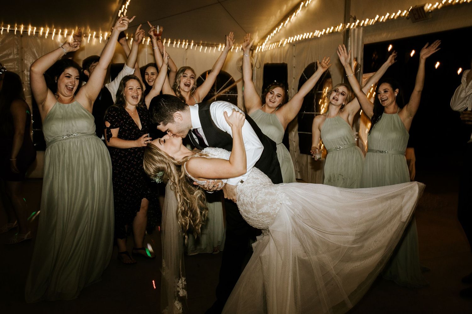 Dynamic wedding reception dance floor scene with light trails and celebratory atmosphere.