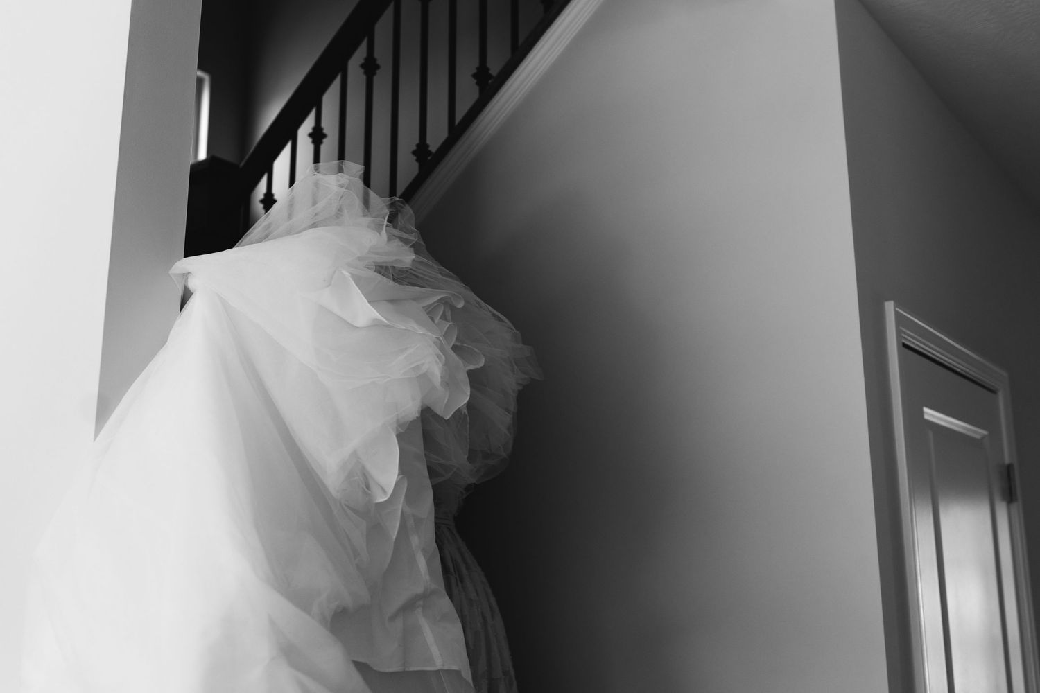Black and white photograph of a staircase and interior details at a wedding venue.
