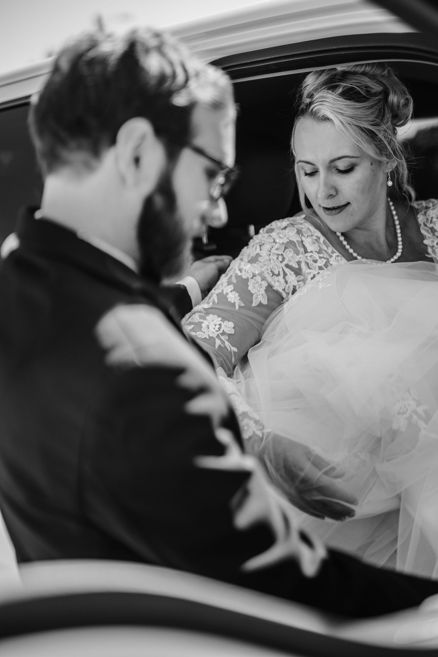 Black and white sequence of newlyweds entering their wedding getaway car.