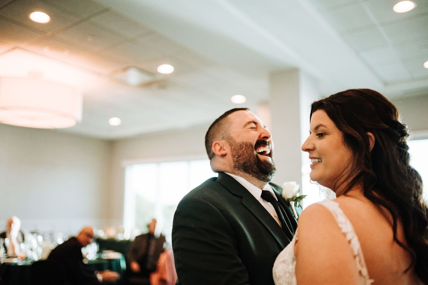 A candid moment of laughter during a wedding reception.