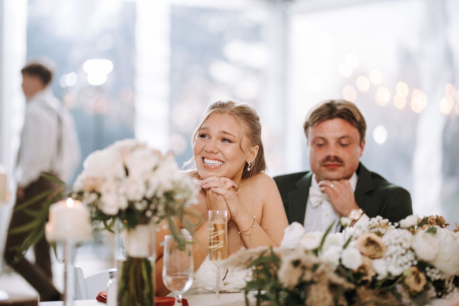 Wedding reception tables set with elegant decor and floral centerpieces.