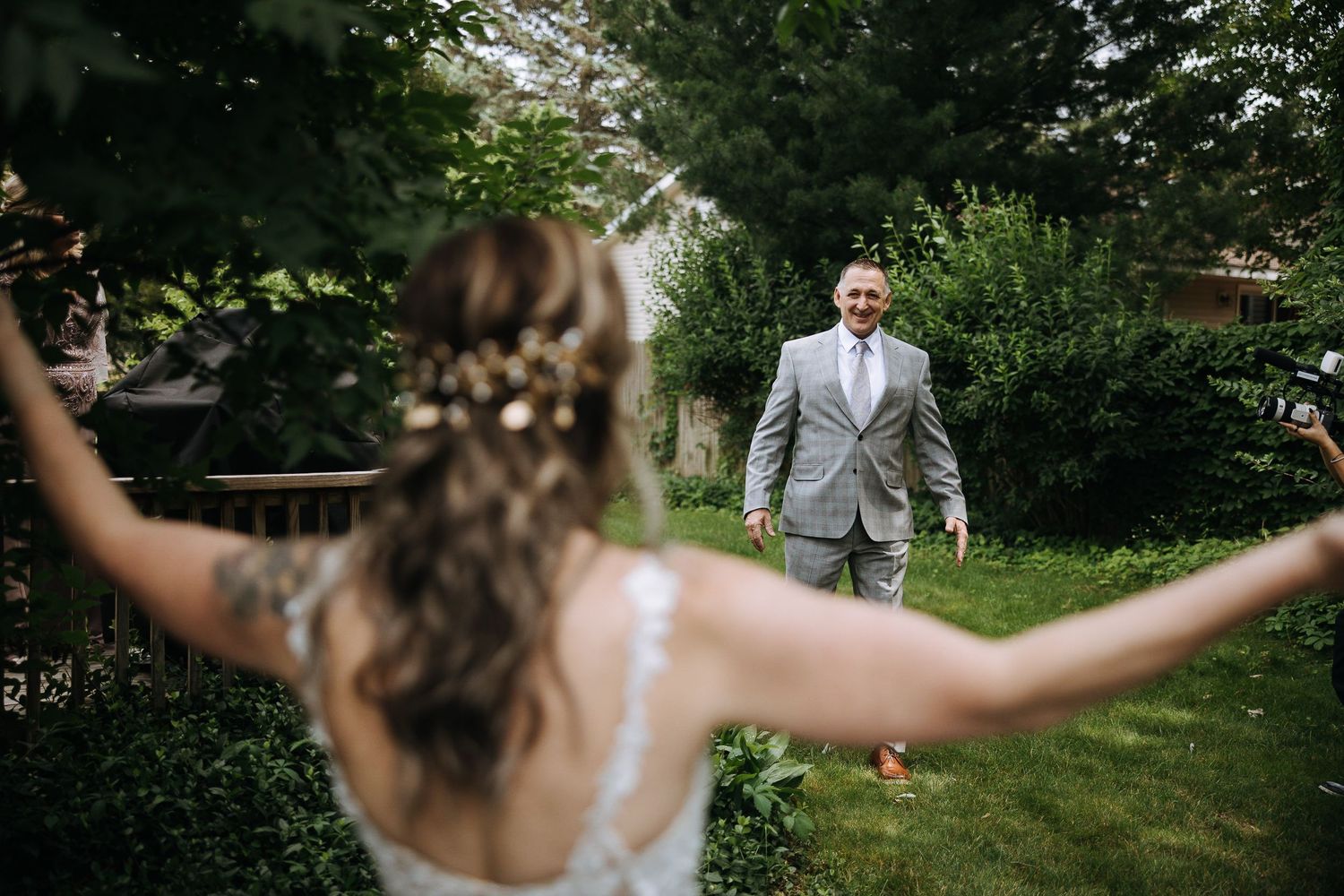 Playful first look moment captured in lush garden setting.