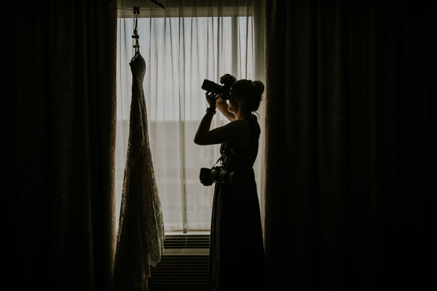 Silhouetted figures against window light creating dramatic shadows.