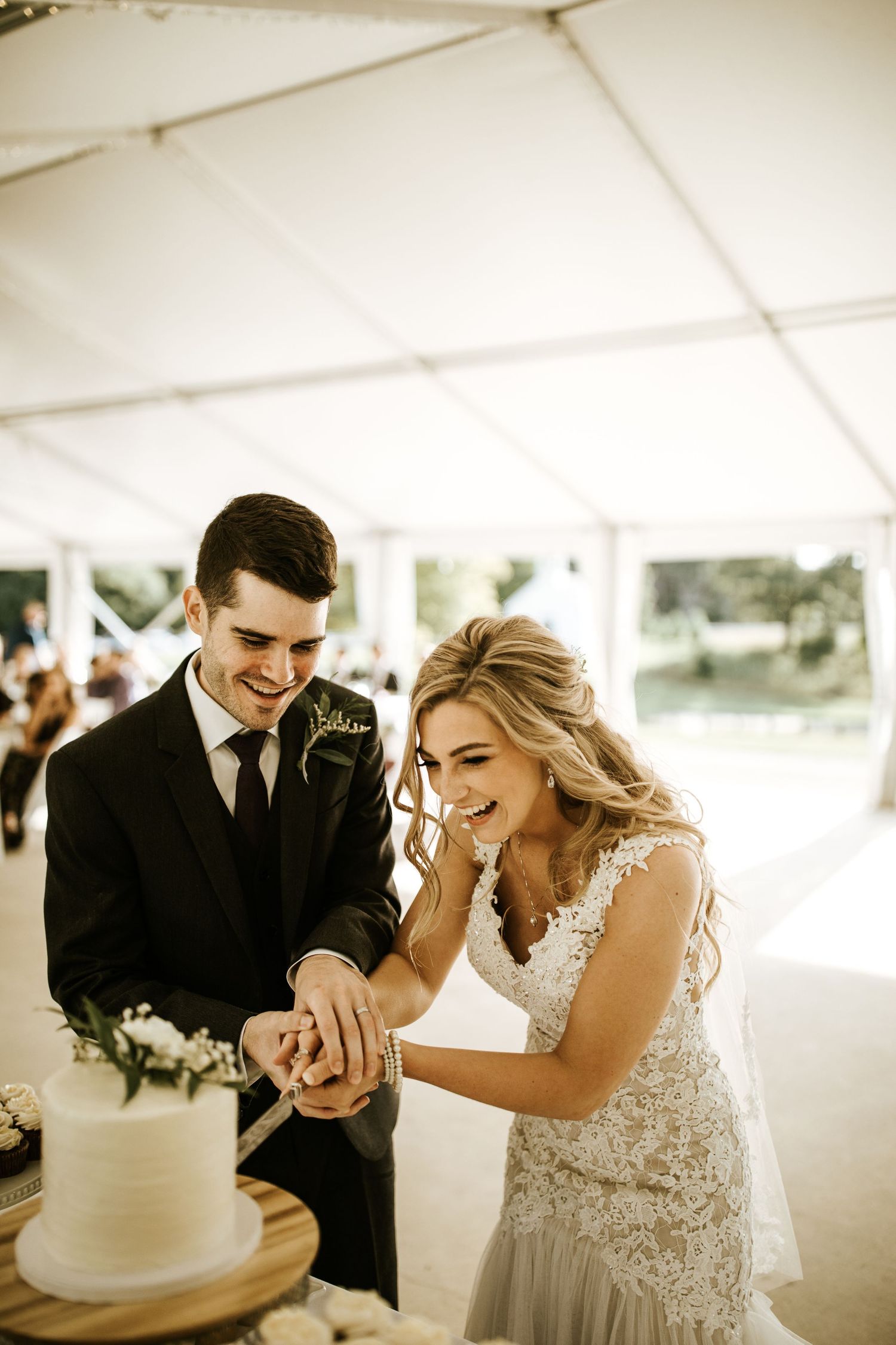 Candid moments of celebration under white tent at outdoor wedding reception.