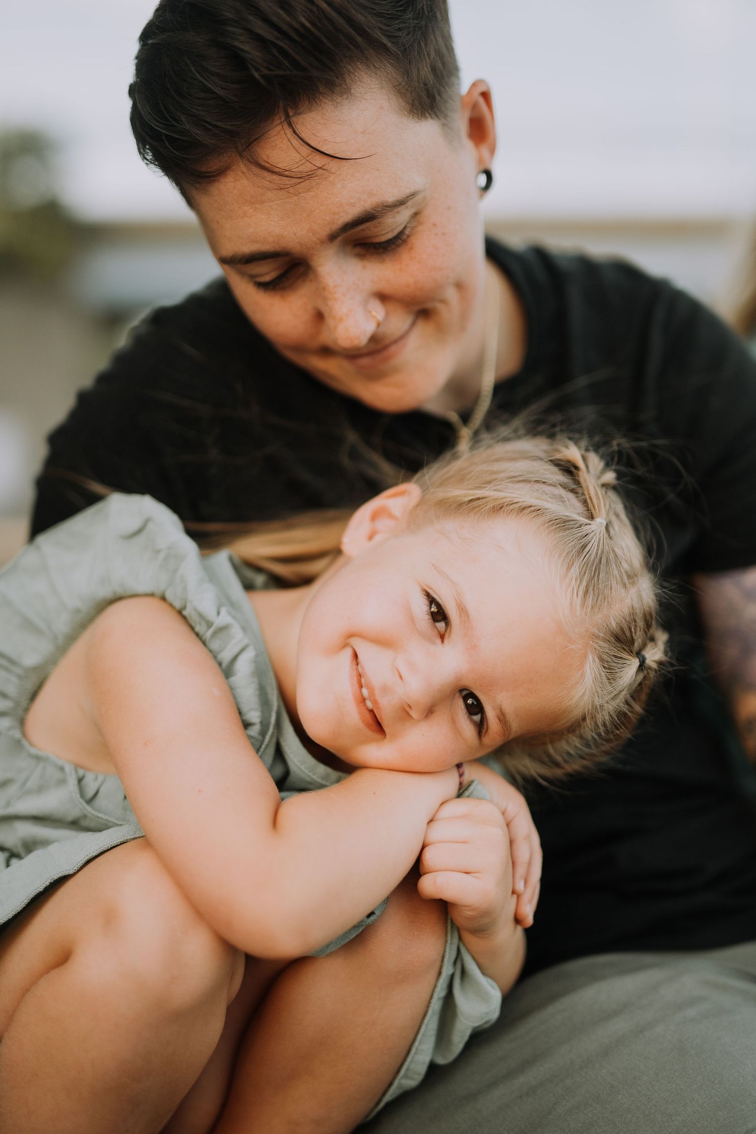 Intimate close-up portrait of tender family moment on a couch.