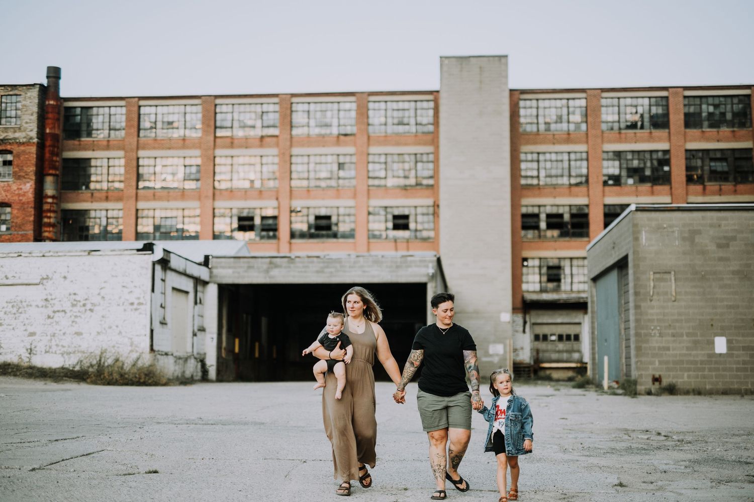 Group walking along concrete path near modern building complex.