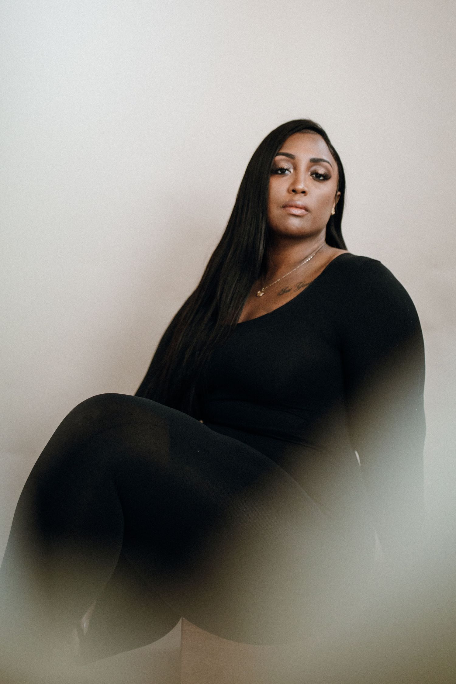 Moody portrait series with soft lighting showing artistic poses in black attire.