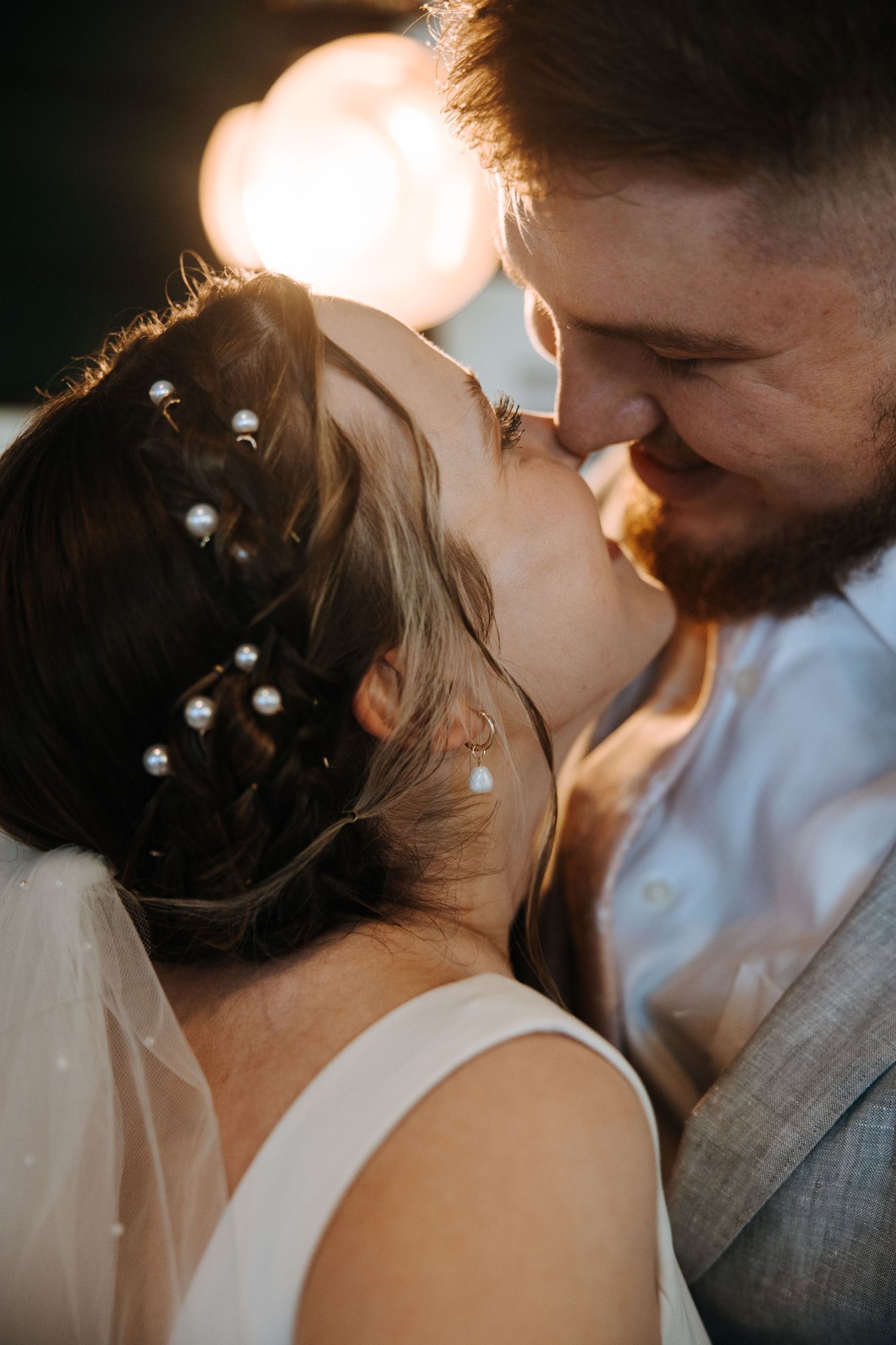 Intimate close-up moment captured in warm golden lighting.