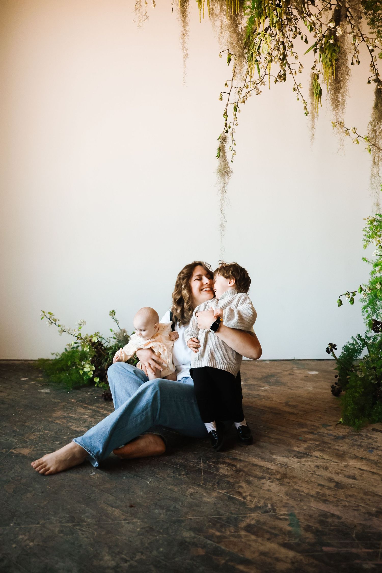 Romantic couple lounging together on ground beneath hanging vines in artistic photo sequence.