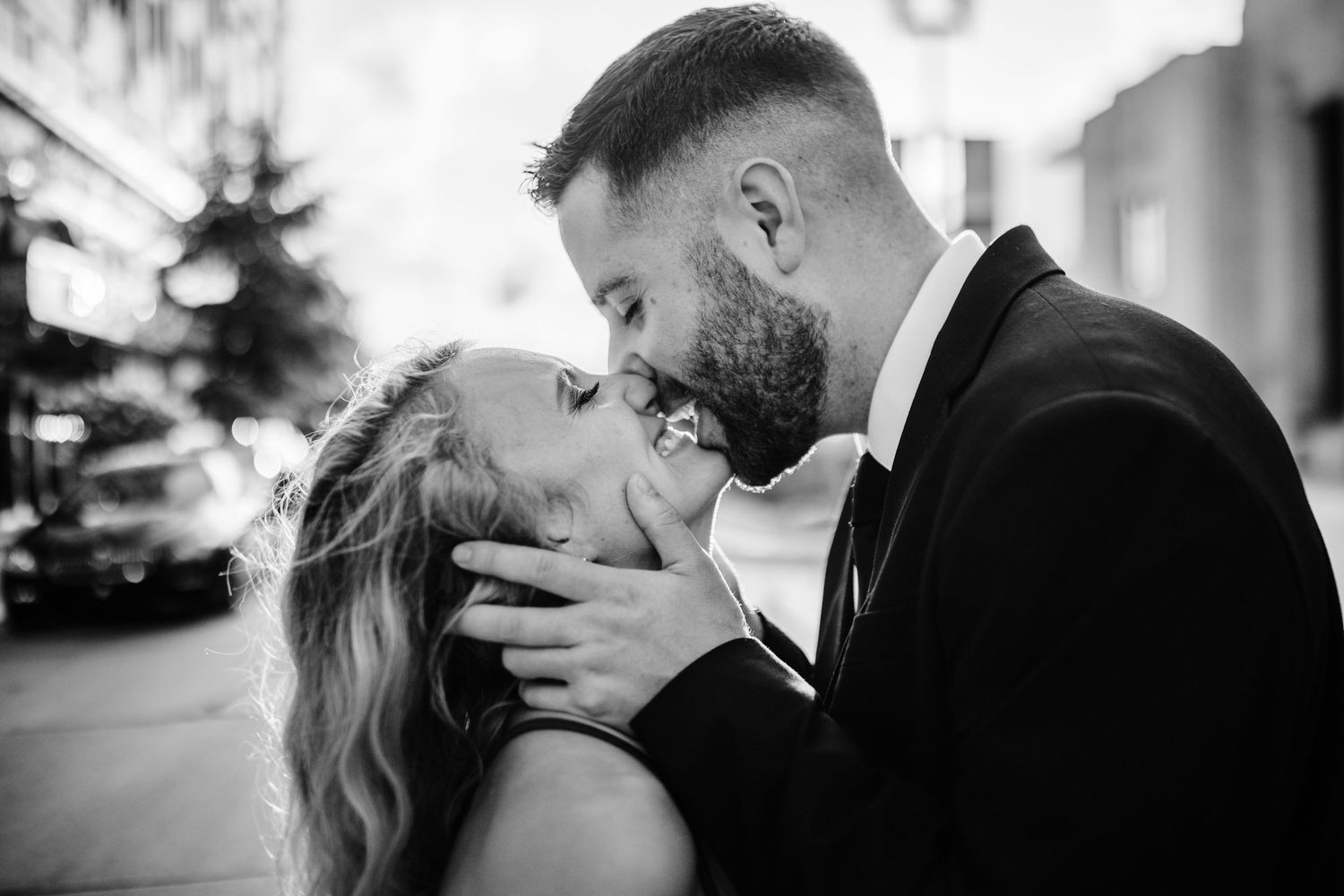 An intimate black and white portrait of a couple sharing a romantic moment.
