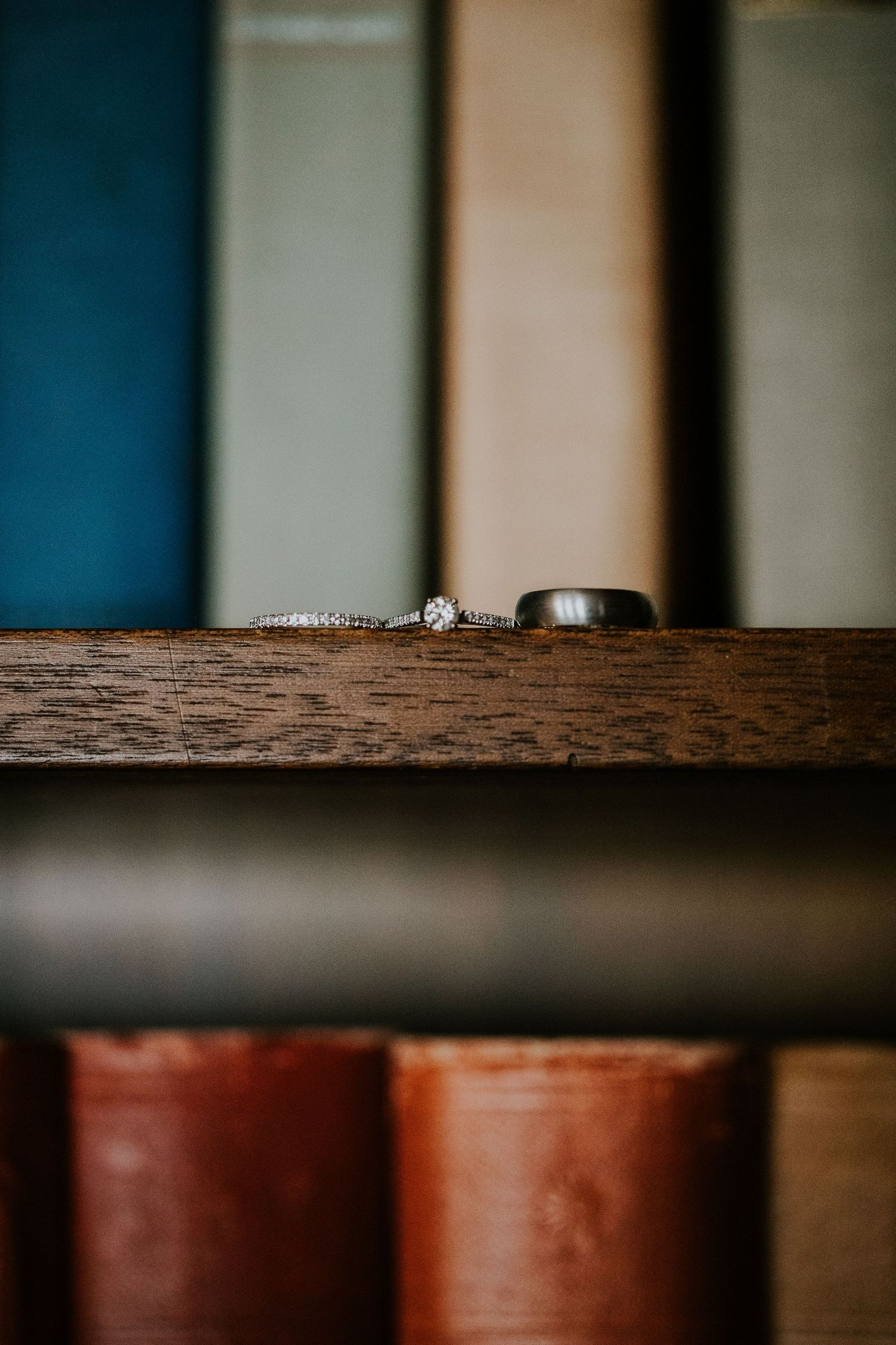 Wedding rings placed on a rustic wooden surface with shallow depth of field.