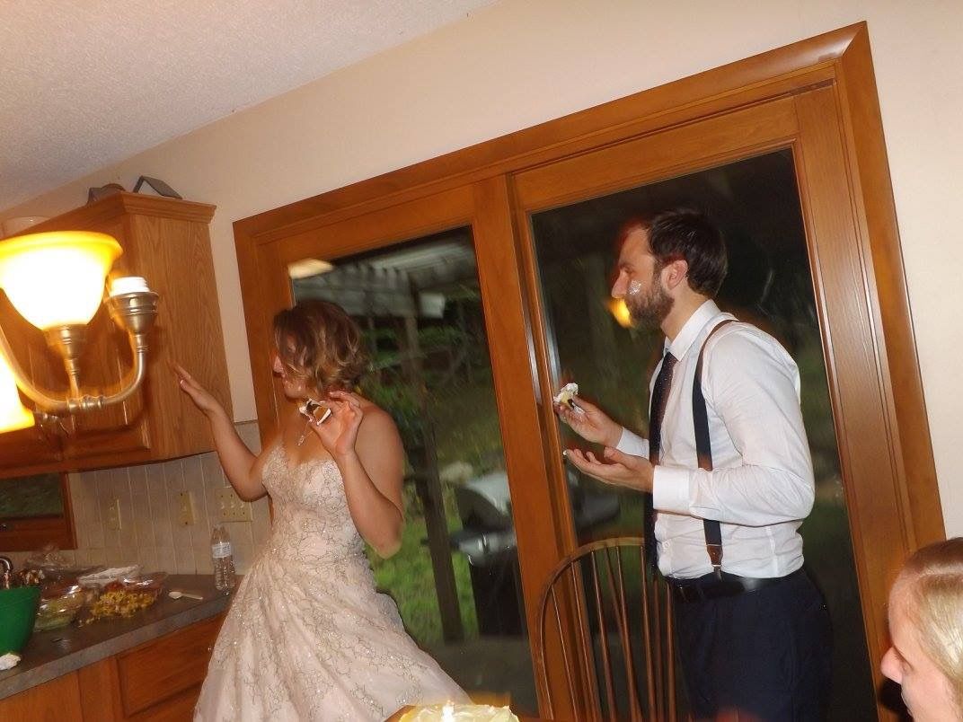 People dancing and celebrating at an indoor reception party.