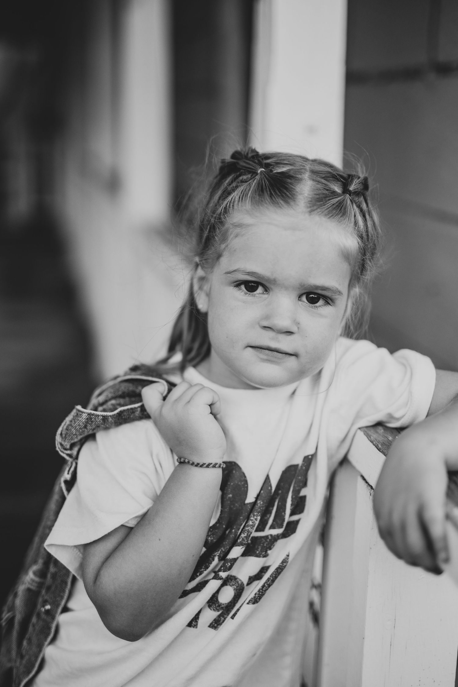 Black and white portrait of child with expressive smile.