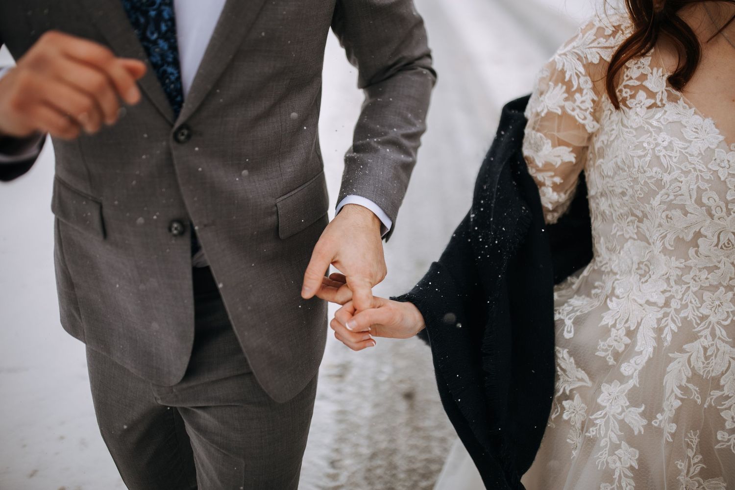 Wedding couple sharing intimate moments during their winter celebration.