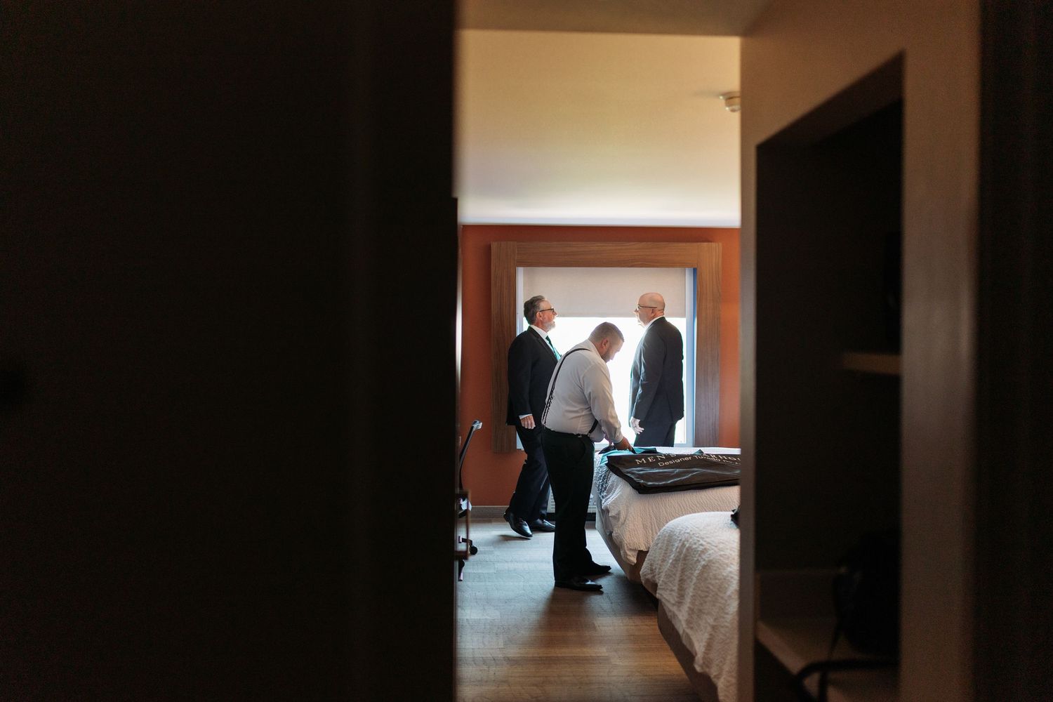 Interior hallway view with natural light streaming through doorways in wedding venue.