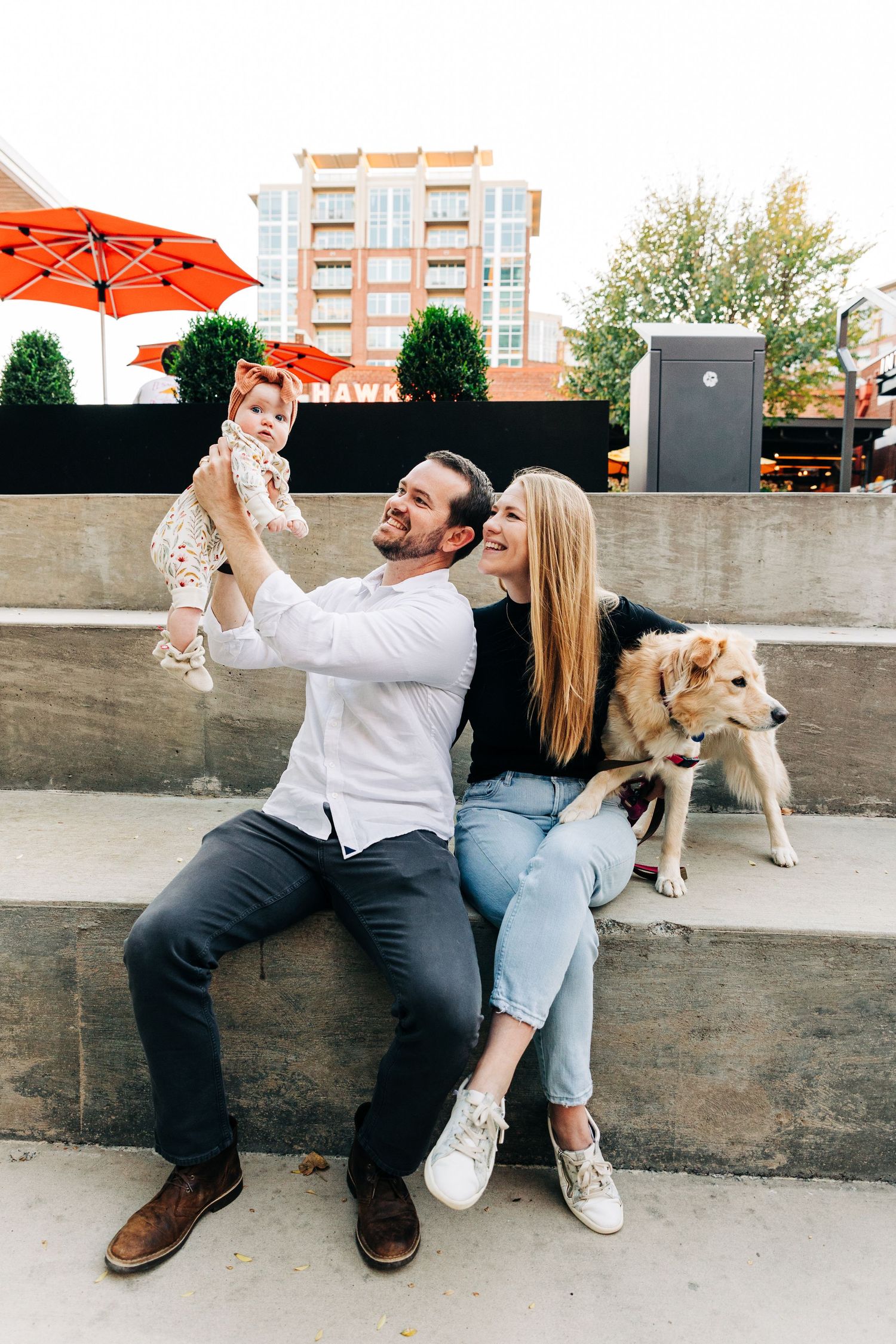a young family poses together in South End Charlotte