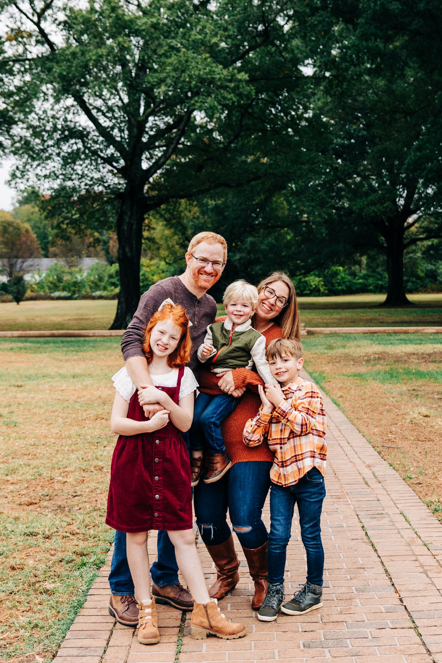 A playful family photo sequence on a brick path showing candid moments of laughter and interaction in an outdoor setting.