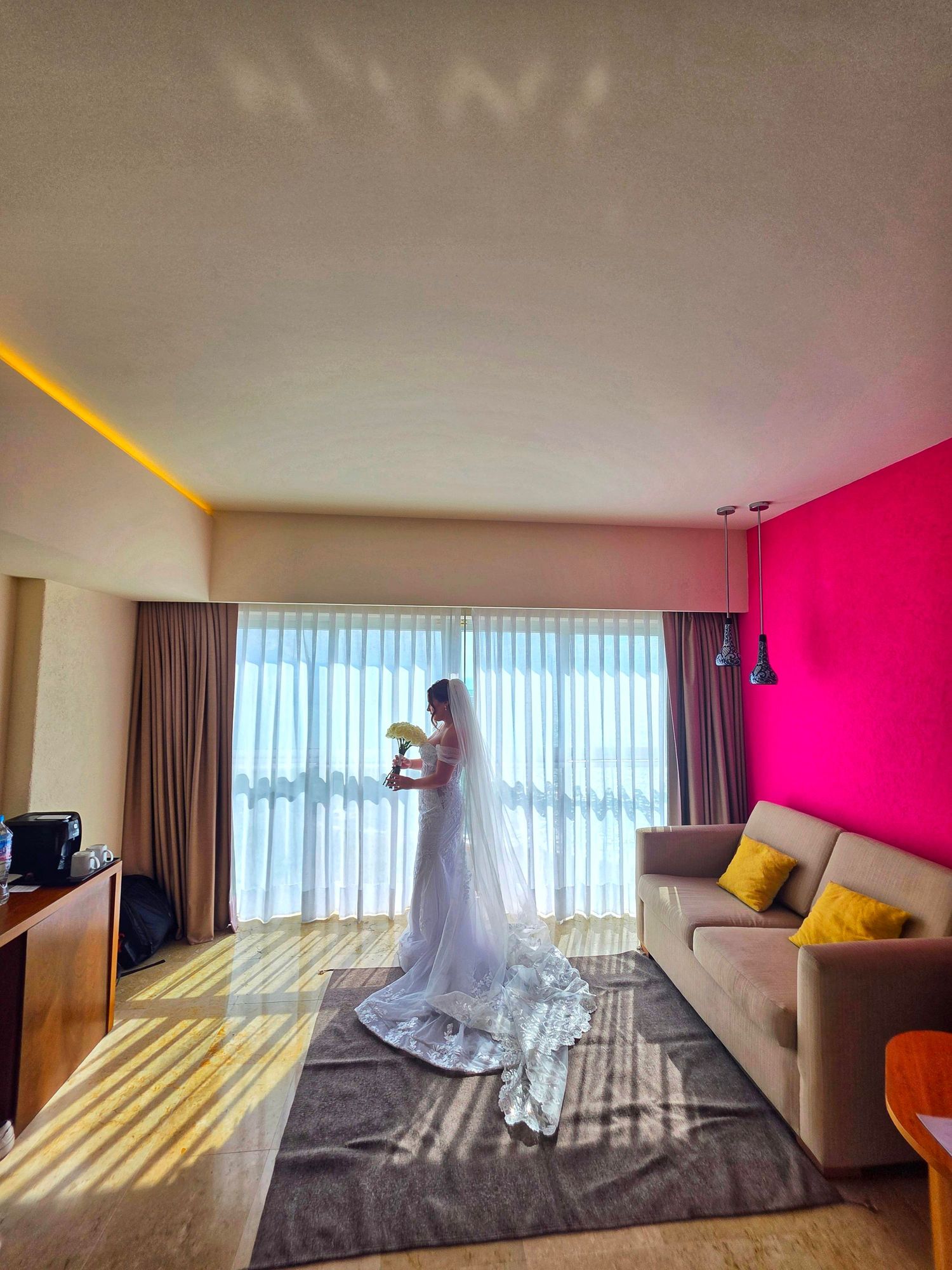 Bride getting ready in a luxury hotel room in Puerto Vallarta with natural light, captured by a wedding content creator