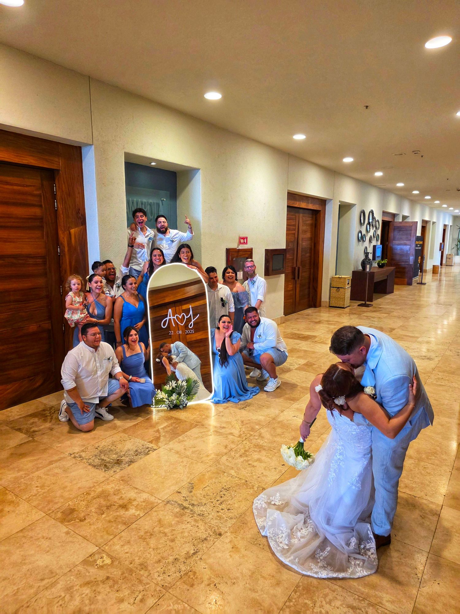 destination wedding couple kiss with guests celebrating indoors in Puerto Vallarta Mexico captured by wedding content creator team real mome