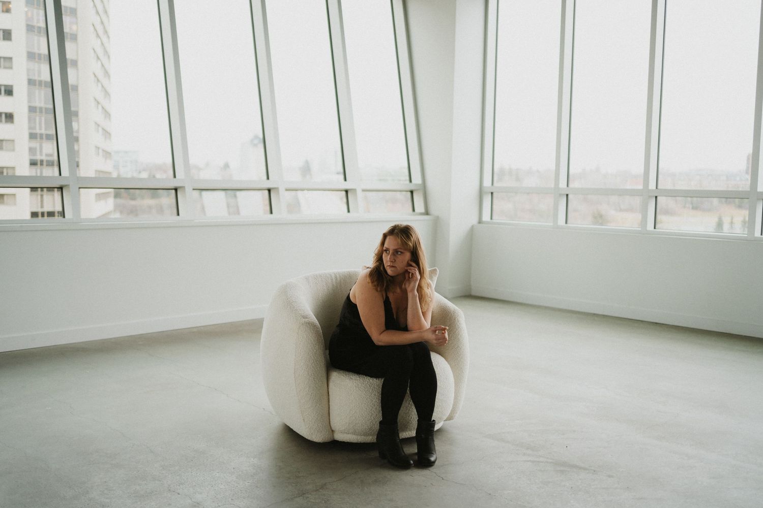 A woman sits in a photo studio
