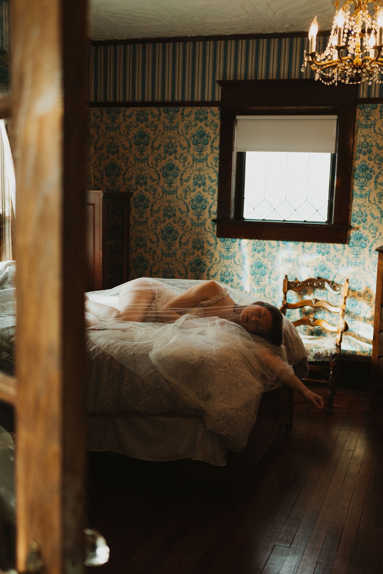 A bride lays on the bed getting ready for her wedding