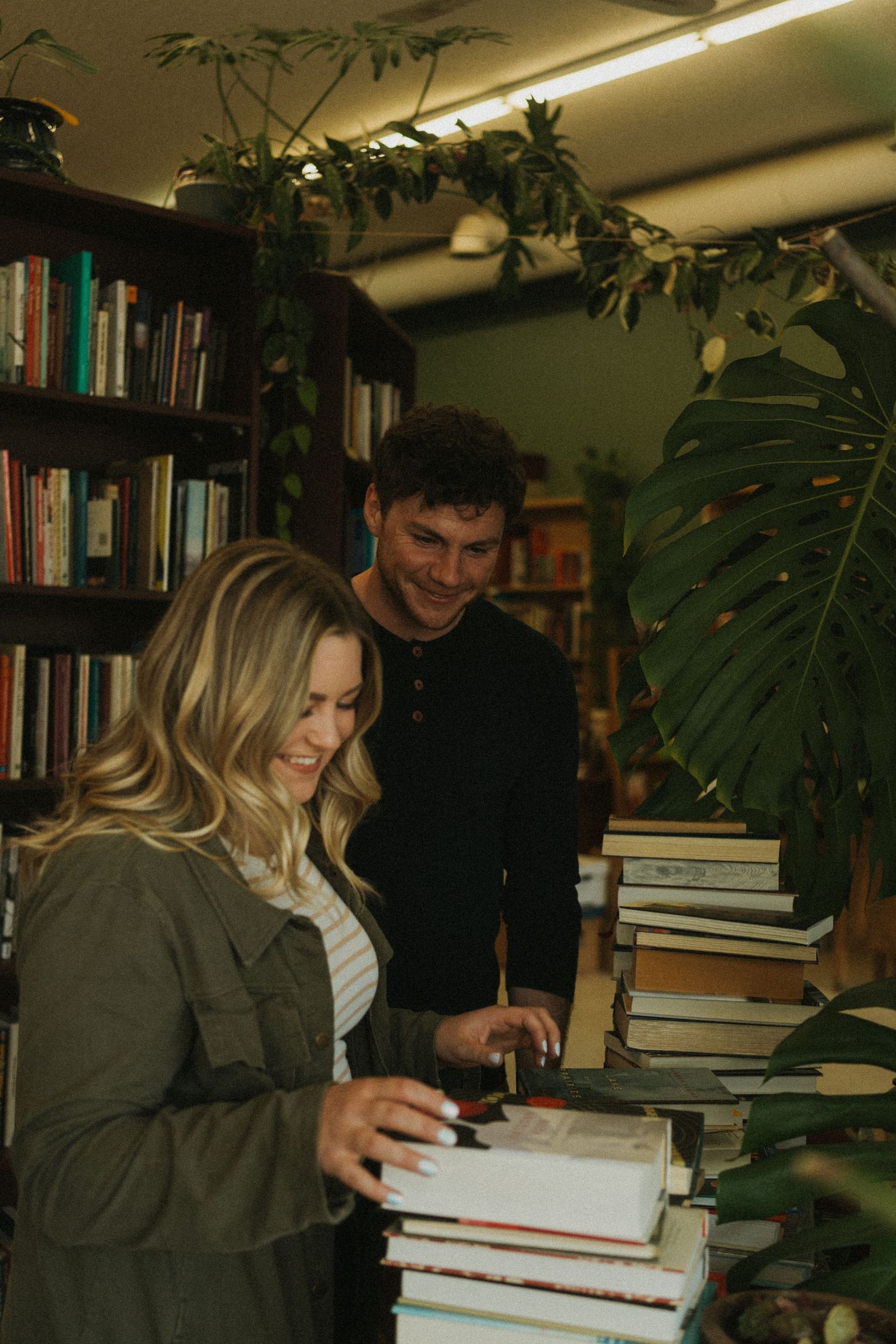 A couple browses the library for their engagement photos.