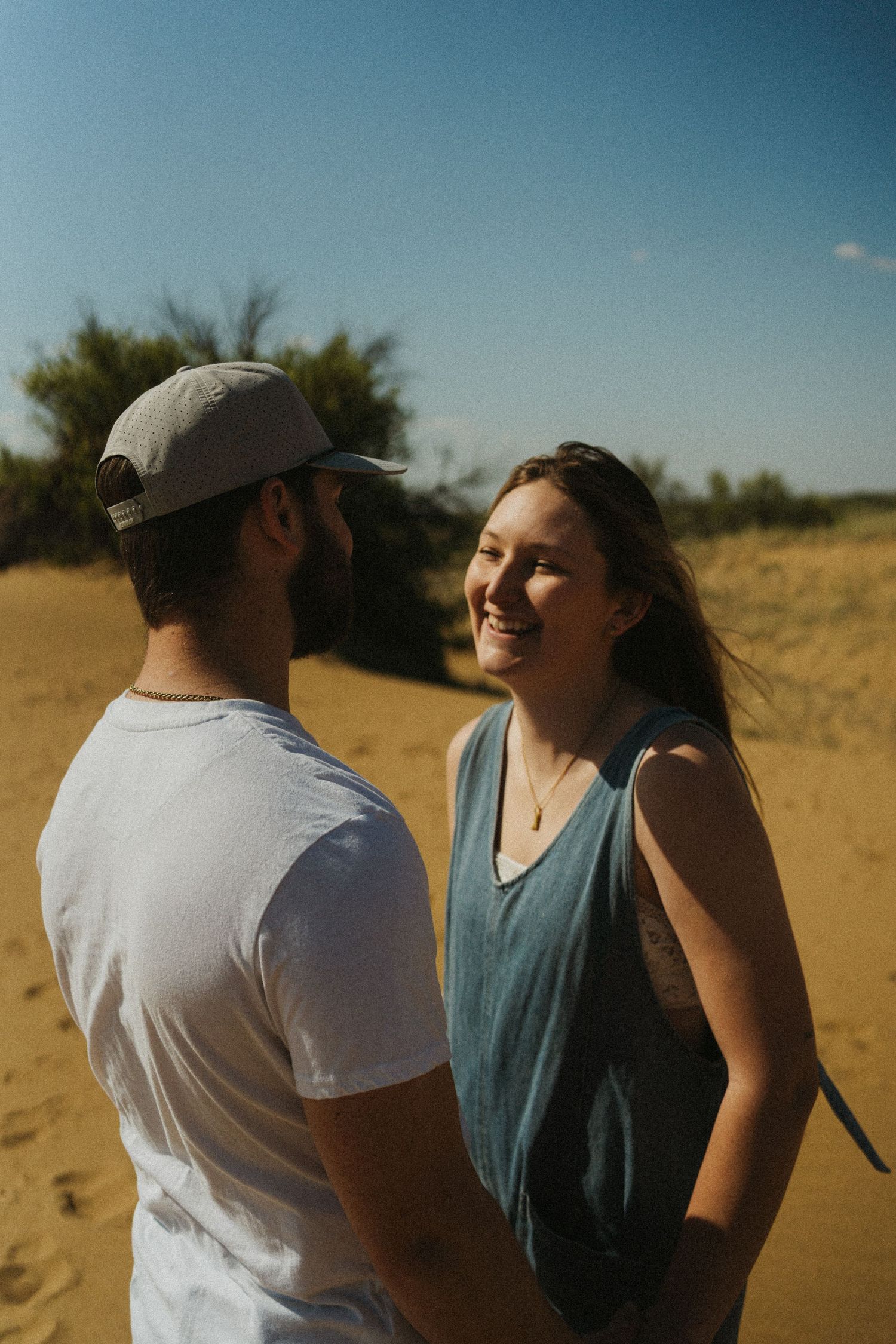 A woman looks lovingly at her boyfriend in the desert