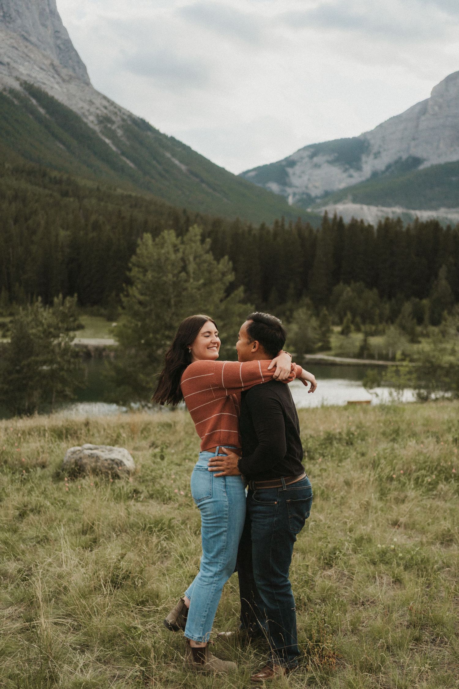 A photo of a couple spinning around and being romantic in Canmore