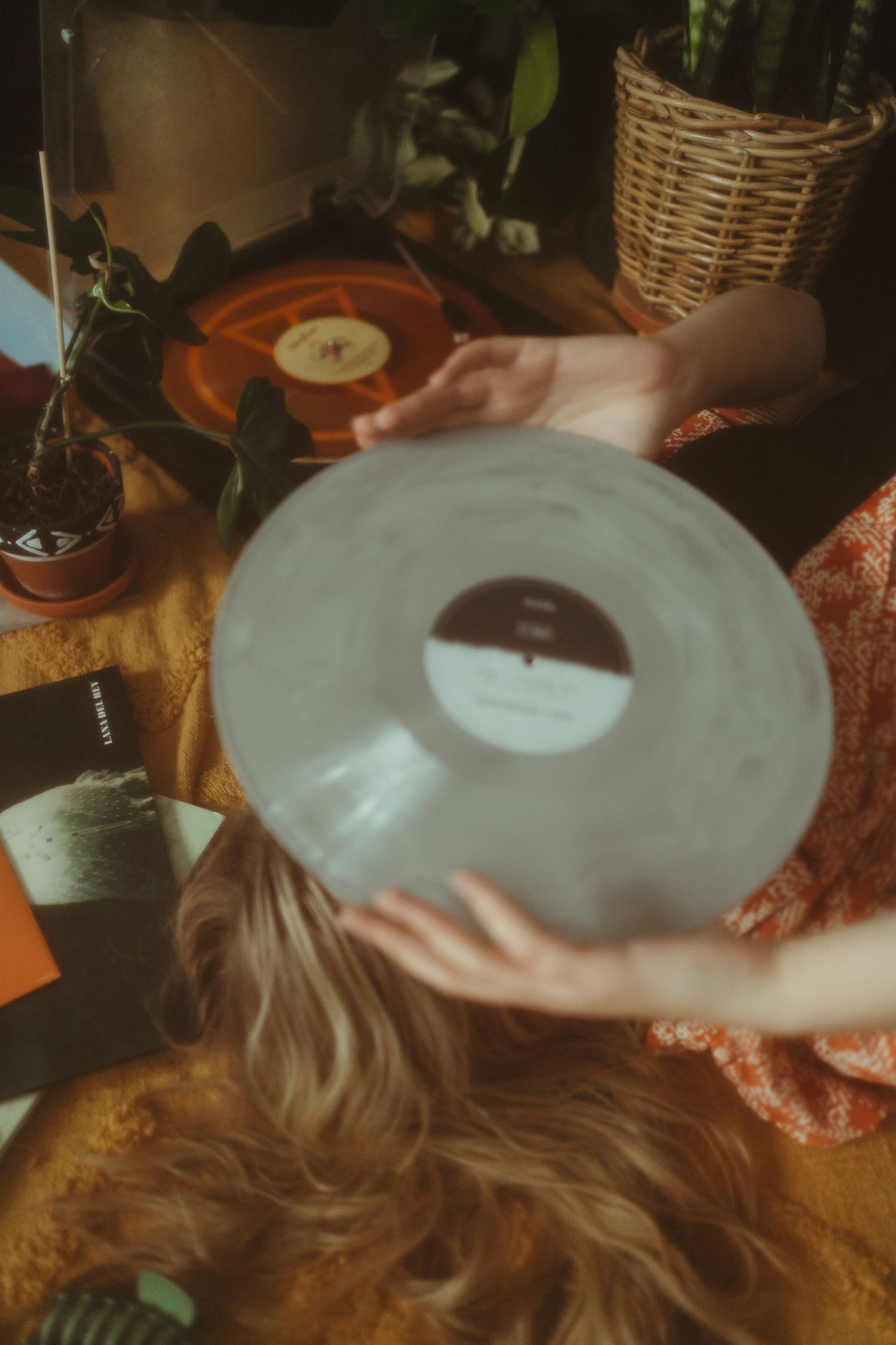 a woman holds a record in front of her face