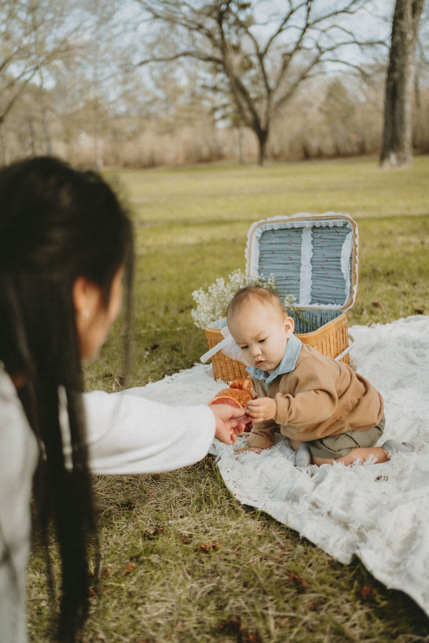 a mother has a picnic with her baby
