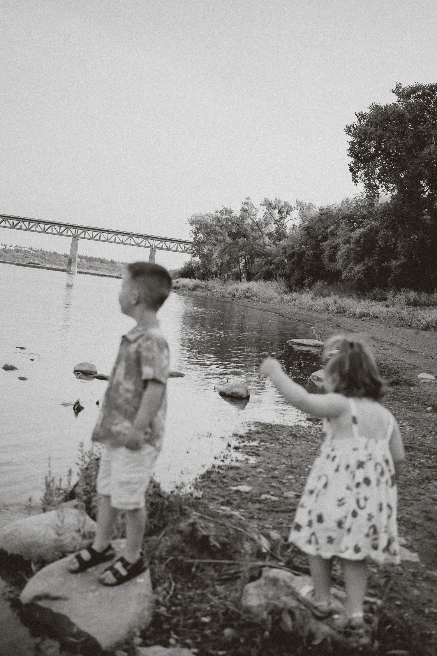 two siblings play at the river