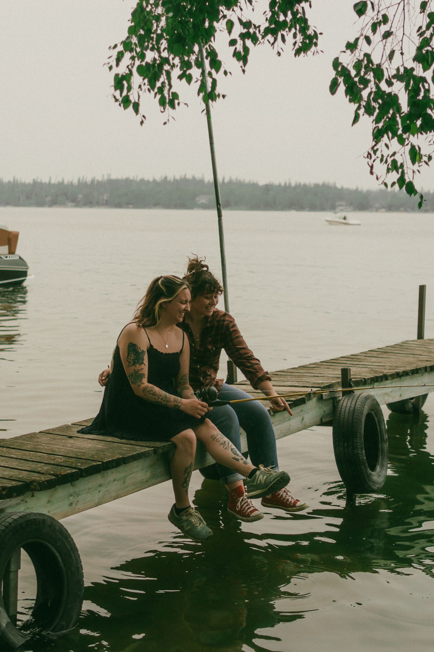 An LGBTQ couple fishes at the lake