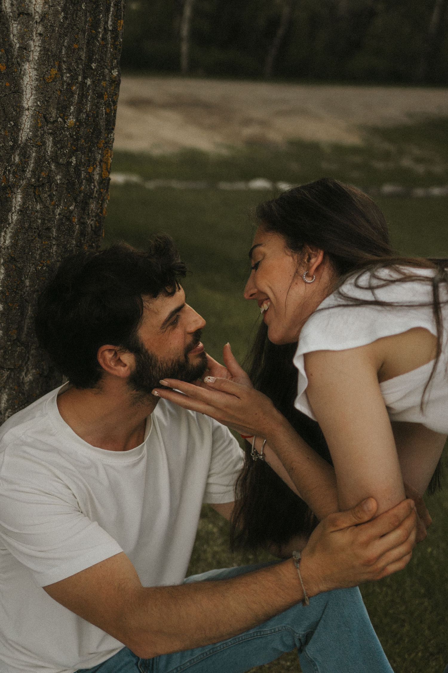 A photo of a couple sharing giggles at a picnic.
