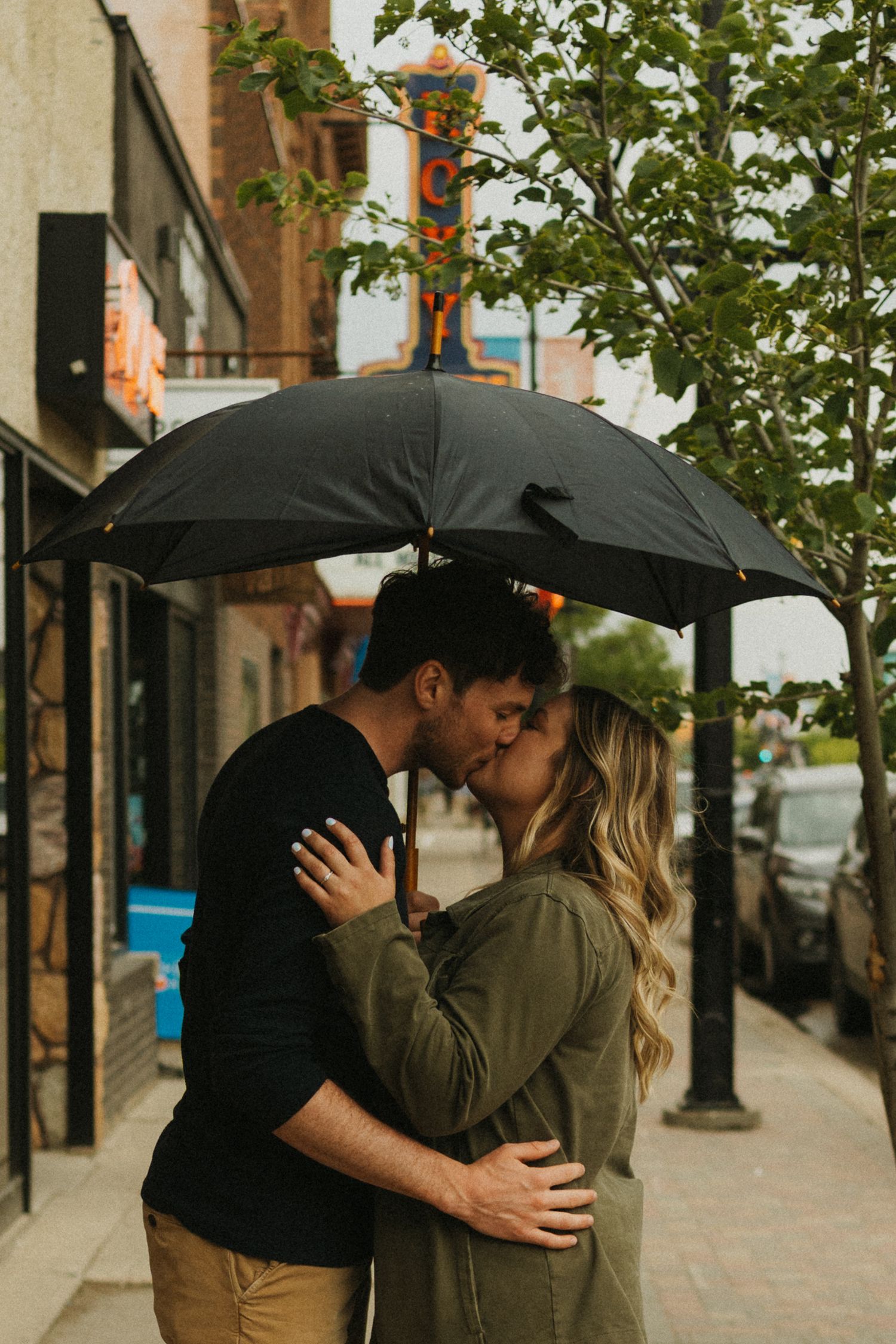 A couple shares a kiss in the rain