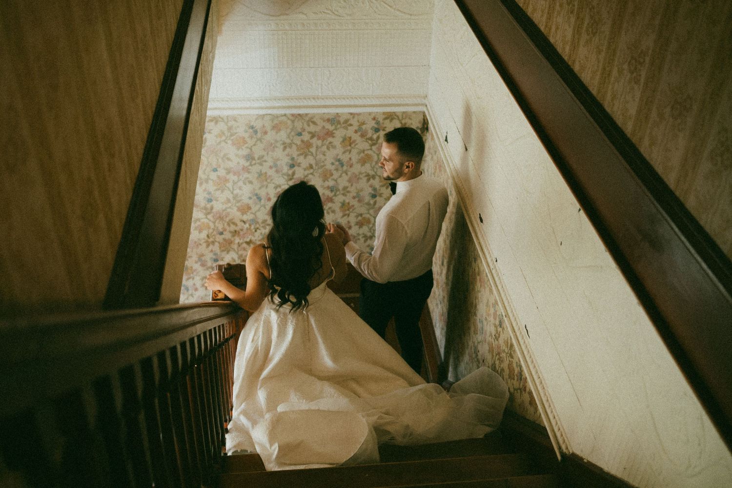 A cinematic photo of a bride and groom in a vintage home