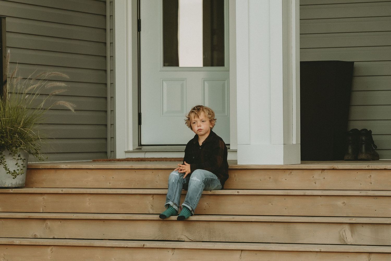 a child sits on the front steps